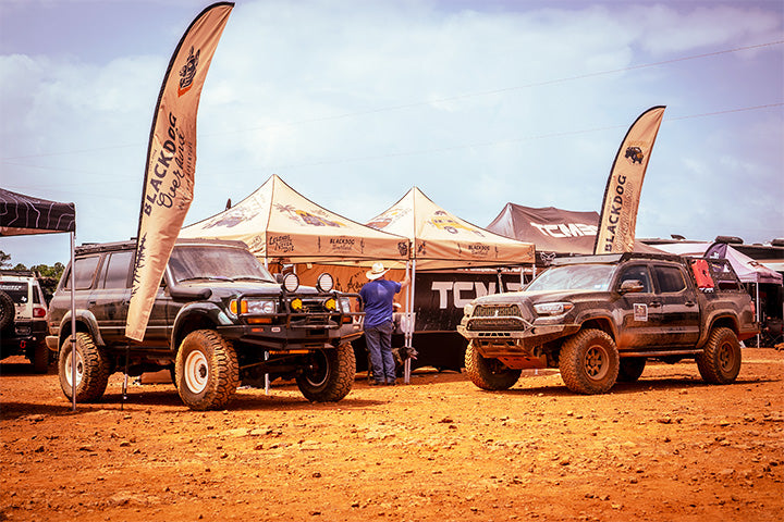 A Land Cruiser and Tacoma in the desert at a Black Dog Overland event